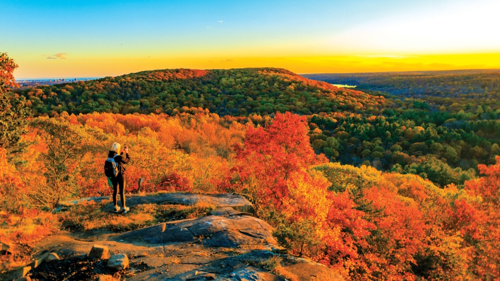 Woman sitting at the peak of Sleeping Giant